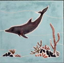 dolphin swiming over reef in blue water
